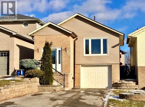 Split-level residence featuring a brick and siding facade, an integrated single-car garage, and a front entry with wrought iron railing - 599 Upper Horning Road Unit# Main/Upper, Hamilton, ON 