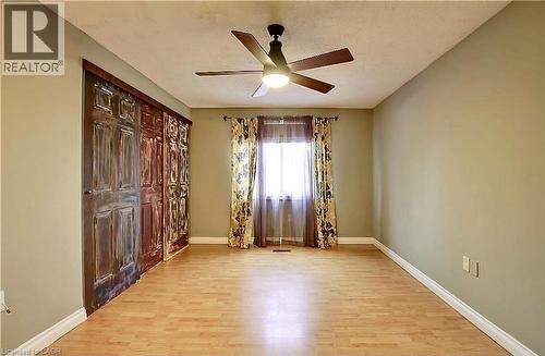 Bright room featuring light wood-finish flooring, a contemporary ceiling fan, and a window with natural light - 599 Upper Horning Road Unit# Main/Upper, Hamilton, ON 