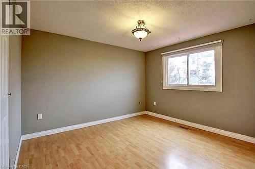 Room featuring light wood-finish flooring, neutral wall paint, and white baseboards - 599 Upper Horning Road Unit# Main/Upper, Hamilton, ON 