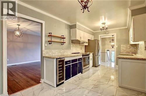 Kitchen featuring white upper cabinetry, dark lower cabinetry, and stainless steel appliances - 599 Upper Horning Road Unit# Main/Upper, Hamilton, ON 