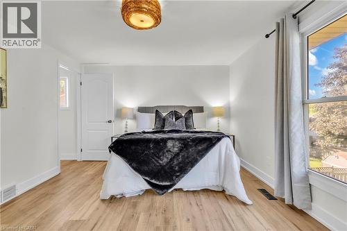Room featuring wood-finish flooring and white baseboards - 127 Acorn Crescent, London, ON 
