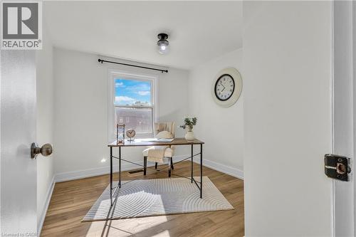 Bright room with a window, wood-finish flooring, white walls, and a ceiling-mounted light fixture - 127 Acorn Crescent, London, ON 