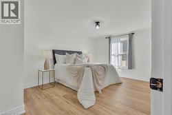 Light wood-finish flooring complements the neutral wall tones - 