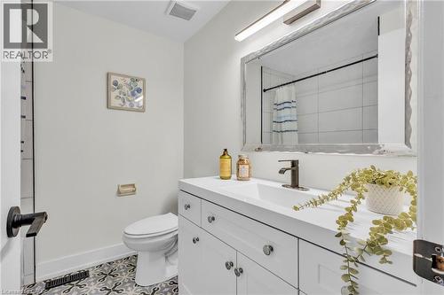 Bathroom featuring a white vanity with integrated sink, bronze-finish faucet, and coordinating hardware - 127 Acorn Crescent, London, ON 