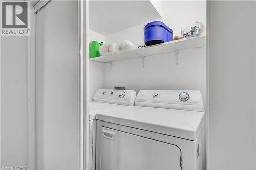 Dedicated laundry area featuring a white top-load washing machine and front-load dryer - 127 Acorn Crescent, London, ON 