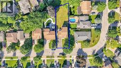 Expansive property with a substantial undeveloped lot, mature trees, and a curvilinear street layout - 
