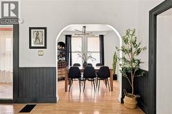 Archway framing a dining area with wood-finish flooring - 