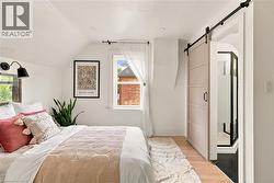 Angled ceiling room with wood-finish flooring - 