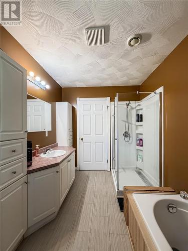 Main floor bathroom with jacuzzi tub and stand up shower - 100A Main Road, Lewin'S Cove, NL 