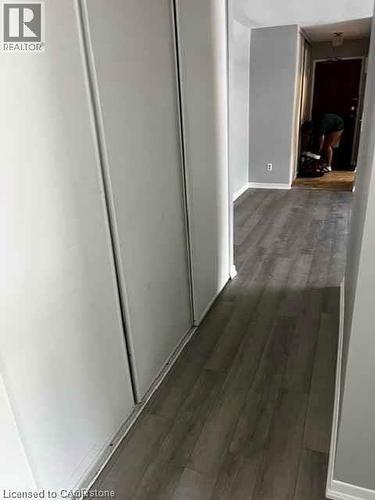 Hallway featuring wood-finish flooring and light gray walls - 529 Parkside Drive Unit# 7, Waterloo, ON 
