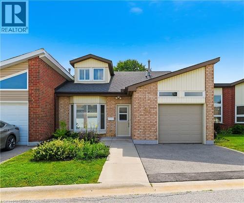 Brick exterior with an attached garage and a concrete driveway - 29 Archdeacon Clark Trail, Hamilton, ON 