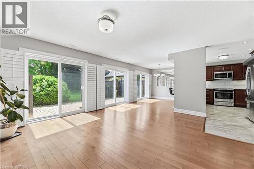 Spacious room with light wood-finish flooring and light gray wall paint - 29 Archdeacon Clark Trail, Hamilton, ON 