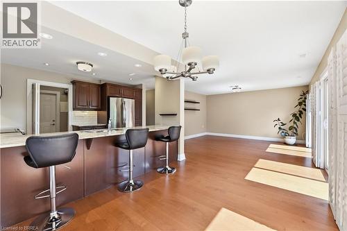 Open-concept living area featuring wood-finish flooring and neutral wall tones - 29 Archdeacon Clark Trail, Hamilton, ON 