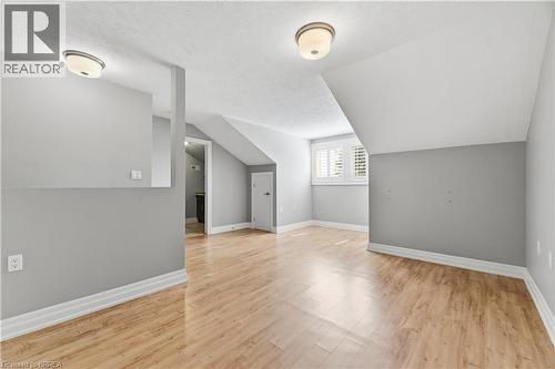 Open room featuring light wood-finish flooring and sloped ceilings - 29 Archdeacon Clark Trail, Hamilton, ON 