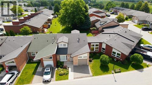 Residential property featuring an attached garage, paved driveway, and manicured landscaping - 29 Archdeacon Clark Trail, Hamilton, ON 