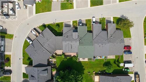 Aerial perspective showcasing a residential street with multiple properties, each featuring a private grassy yard - 29 Archdeacon Clark Trail, Hamilton, ON 