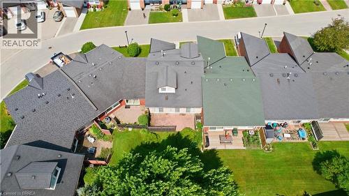 Residential property featuring a shingle roof and a spacious backyard with a patio - 29 Archdeacon Clark Trail, Hamilton, ON 