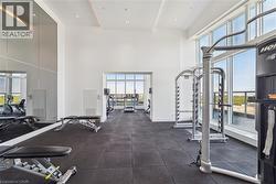 Fitness center featuring high ceilings, rubber flooring, and full-height mirrors - 