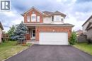 Two-story residence featuring a brick and siding exterior, an attached two-car garage, and a paved driveway - 566 Avignon Place, Waterloo, ON 