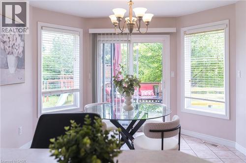 Dining area featuring a bay window with three large windows and a glass sliding door - 566 Avignon Place, Waterloo, ON 