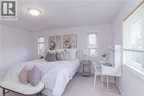 Carpeted room with multiple windows, each featuring horizontal blinds - 566 Avignon Place, Waterloo, ON 