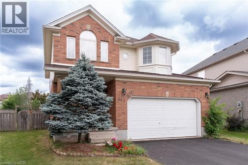 Brick and siding exterior featuring a prominent arched window and a bay window detail - 566 Avignon Place, Waterloo, ON 