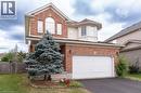 Brick and siding exterior featuring a prominent arched window and a bay window detail - 566 Avignon Place, Waterloo, ON 