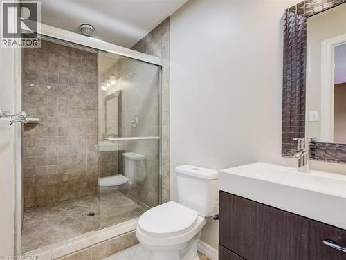 Enclosed shower with sliding glass door and decorative tile surround - 123 Forest Edge Trail, Kitchener, ON - Indoor Photo Showing Bathroom