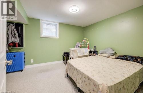 Carpeted room featuring a white-framed window, a built-in open closet, and white baseboards - 123 Forest Edge Trail, Kitchener, ON - Indoor Photo Showing Bedroom