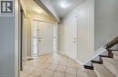 Entryway featuring a white paneled front door with sidelights, tile flooring, and a mirrored closet - 123 Forest Edge Trail, Kitchener, ON 