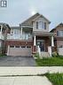 Two-story residential property featuring a brick and siding facade, an integrated two-car garage with window accents, and a covered main entrance - 235 Apple Hill Crescent, Kitchener, ON 