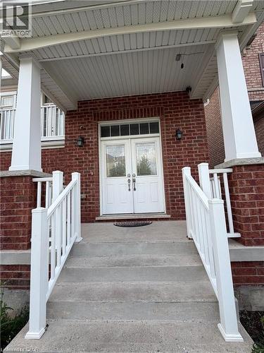 Brick facade featuring a covered porch entry - 235 Apple Hill Crescent, Kitchener, ON 
