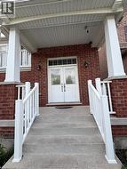 Brick facade featuring a covered porch entry - 