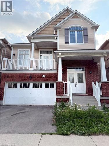 Two-story residence featuring a brick first level and light-colored siding on upper levels - 235 Apple Hill Crescent, Kitchener, ON 
