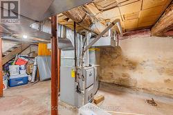 Concrete floor in bsmt with many steel jackposts. - 