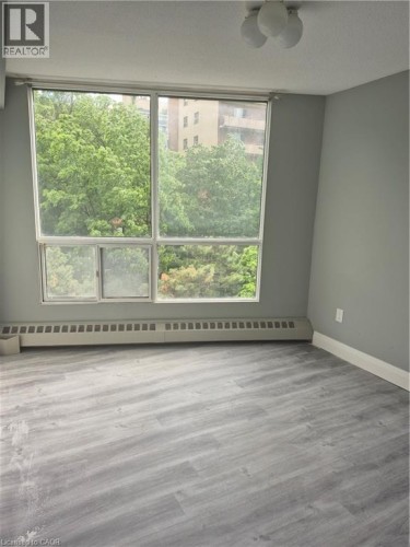Large window framing exterior greenery - 150 Charlton Avenue E Unit# 708, Hamilton, ON 