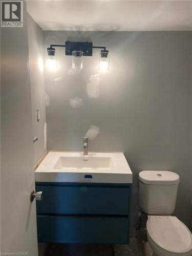 Floating vanity with two storage drawers, integrated white sink, and single-lever faucet - 150 Charlton Avenue E Unit# 708, Hamilton, ON 