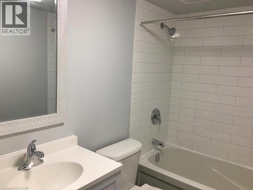 Full bathroom featuring a white subway tile shower, chrome shower fixtures, and a white bathtub - 92 Pattandon Avenue Unit# C, Kitchener, ON - Indoor Photo Showing Bathroom