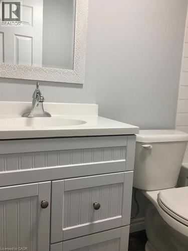 White beadboard vanity with a solid white countertop and integrated sink - 92 Pattandon Avenue Unit# C, Kitchener, ON - Indoor Photo Showing Bathroom