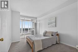 Floor-to-ceiling windows with sliding glass door access to an outdoor balcony - 