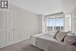 Room featuring a panoramic window wall, light gray walls, and carpet flooring - 