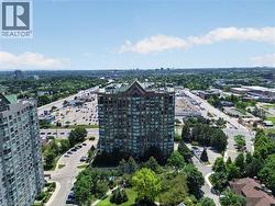 High-rise building featuring a multi-story facade, numerous windows, and a distinctive peaked roof - 