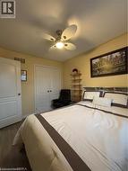 Room featuring wood-finish flooring, a ceiling fan with integrated lighting, and light-toned walls - 
