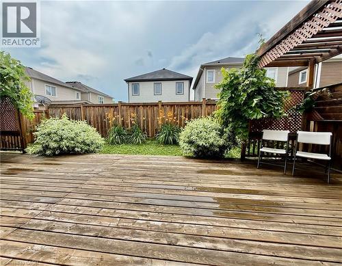 Expansive wood-finish deck with an integrated pergola and lattice detailing - 386 Apple Hill Crescent, Kitchener, ON 