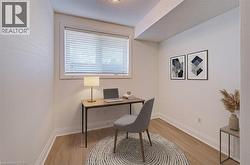 Office space featuring light wood finished floors and a textured ceiling - 