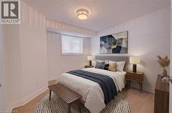 Bedroom with light wood-style floors and baseboards - 