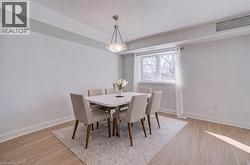 Dining area with light wood-type flooring and a textured ceiling - 