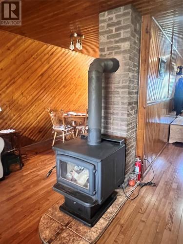 47 Mahers Road, Mahers, NL - Indoor Photo Showing Other Room With Fireplace