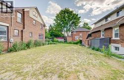 Expansive grass lawn with mature trees bordering the property - 