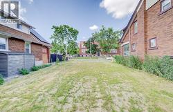 Expansive grassy lot with surrounding brick and siding structures - 